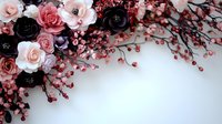 Elegant floral corner arrangement with pink and black roses, white blossoms and red berries on white background. Romantic wedding and celebration design element.
