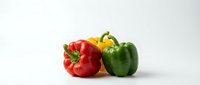 Fresh red, yellow, and green bell peppers isolated on white background, ready for culinary, food, nutrition, and healthy eating design projects.
