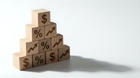 Wooden blocks stacked in pyramid formation displaying financial symbols including dollar signs, percentage marks and growth arrows on neutral background.