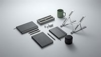 Modern minimalist workspace setup with gray notebooks, laptop stand, green mug and black accessories arranged on clean white surface for productivity.