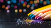 Colorful wooden pencils with scattered glitter sparkles on dark background creating magical artistic composition. Creative stationery concept for art and education.