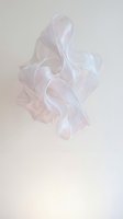 Translucent white silk fabric flowing gracefully through air creating elegant waves and curves against neutral background for luxury fashion design.