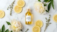 Herbal essential oil bottle surrounded by fresh lemon slices, white peonies, and dried botanicals on marble surface for wellness and skincare branding.