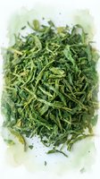 Dried green tea leaves isolated on white background, ready for beverage preparation, culinary use, and wellness product packaging.
