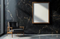 Modern interior with black marble wall, wooden frame mockup and mid-century armchair in dark leather. Natural light casting shadows creates elegant atmosphere.