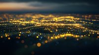 Aerial view of urban cityscape at night with golden bokeh lights creating abstract pattern against dark sky. Perfect for backgrounds.