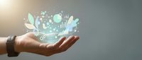 Hand holding glowing digital hologram with data analytics icons, charts, and leaf symbols representing sustainable business growth and eco-friendly technology innovation.