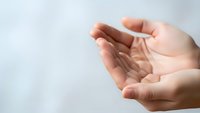 Open cupped hands in receiving gesture against soft blurred background suggesting prayer, hope, giving, receiving or spiritual connection concepts.