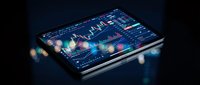 Digital tablet displaying financial trading charts and market data analysis with colorful bokeh lights creating modern investment technology atmosphere.