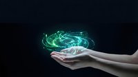 Hands holding glowing green digital energy sphere with swirling light effects on dark background for technology and innovation concepts.