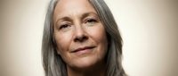 Senior woman with long gray hair and fair complexion, displaying a calm, confident expression. Suitable for healthcare, wellness, aging gracefully, and lifestyle editorial use.