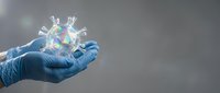 Medical professional in blue gloves holding holographic coronavirus model with rainbow prism effect for healthcare education and virus research concepts.