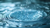 Mesmerizing macro shot of water droplets creating concentric ripples on turquoise water surface with floating bubbles and dynamic splash effect. Perfect for wellness concepts.