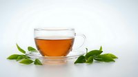 Glass cup of herbal tea with fresh green leaves on white background. Natural hot beverage for wellness and relaxation concepts.