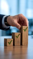 Businessman hand placing wooden blocks with green checkmarks showing business growth, success and achievement in modern office environment.
