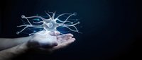 Human hand holding glowing neuron cell with synapses floating above palm against dark background for medical and scientific presentations.