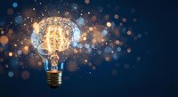 Glowing vintage light bulb with sparkling particles and bokeh effects on dark blue background symbolizing creativity and innovation for business concepts.