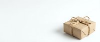 Small kraft paper gift box tied with natural twine bow on clean white background, isolated for holiday and celebration designs.