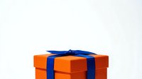 Orange gift box with blue ribbon bow isolated on white background, ready for holiday celebrations, special occasions, and festive design projects.