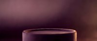 Transparent glass cup with purple liquid against blurred mauve background, suitable for beverage, drink, and product mockup designs.