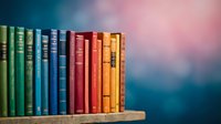 Colorful vintage books arranged on wooden shelf with rainbow gradient background for education and literature concepts.