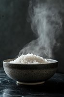Steaming hot white rice in rustic ceramic bowl against dark background, rising steam creates dramatic mood, food photography for restaurant menu or cookbook.