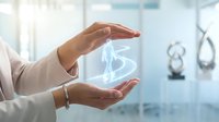 Professional woman hands protecting glowing brain hologram in modern medical office representing mental health care and neurological protection concepts.