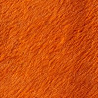 Vibrant orange textured background with diagonal rough lines and grainy surface creates dynamic pattern for creative design projects and wallpapers.