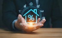 Businessman hands protecting house with percentage symbol and financial icons representing mortgage rates, real estate investment and property loan concepts.