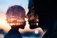 Romantic double exposure silhouette of young couple about to kiss against illuminated city skyline at sunset, creating dreamy urban love story atmosphere.