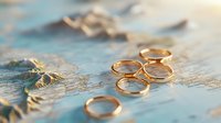 Gold wedding rings on vintage world map, symbolizing travel, destination weddings, and international love stories.