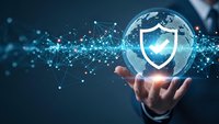 Businessman holding glowing globe with shield icon representing global cybersecurity and data protection in digital network environment.