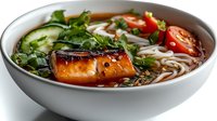 Asian noodle soup bowl with grilled tofu, fresh vegetables, herbs and soba noodles in savory broth for healthy dining and restaurant menu concepts.