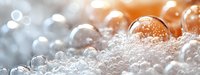 Delicate soap bubbles with orange and blue bokeh light effects create dreamy abstract macro background with soft focus and reflective surfaces.