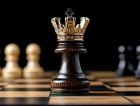 Dark wooden king chess piece with golden crown on chessboard, close-up view against blurred pawns in background. Strategic leadership concept.