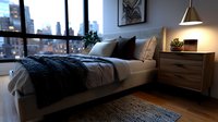 Modern bedroom interior with city view through large windows, featuring cozy bed with gray knitted throw blanket, wooden nightstand and warm lamp lighting.
