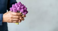 Purple cauliflower held in hand against white background. Fresh organic vegetable for cooking, healthy eating, nutrition, and farmers market concepts.