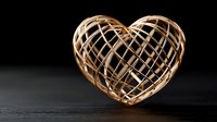 Wooden heart-shaped decorative object with intricate lattice pattern on dark surface, romantic symbol for love concepts and Valentine's Day designs.