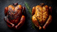 Roasted whole chickens with crispy skin on dark slate background, one smoked and one herb-seasoned, for gourmet food photography.