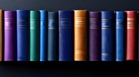Row of vintage hardcover books in various colors including purple, blue, brown and red arranged on dark shelf, spines showing classic binding details and textures.