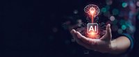 Hand holding glowing brain with AI circuit board symbolizing artificial intelligence, machine learning and neural networks in futuristic technology concept.