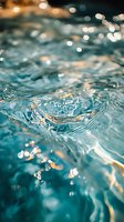 Turquoise water surface with gentle ripples and sparkling light reflections creating a tranquil aquatic scene for wellness and nature backgrounds.