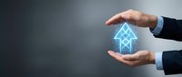 Businessman hands protecting glowing blue house icon with upward arrow symbolizing real estate growth, property investment and home value increase concept.