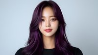 Young Asian woman with vibrant purple hair wearing black top against light background, expressing confidence with natural makeup and gentle smile. Professional portrait.
