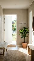 Bright Scandinavian entryway with open door, fiddle leaf fig plant, jute rug, and Welcome sign on neutral textured wall in natural light.