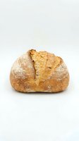 Freshly baked artisan bread loaf with crispy golden crust and flour dusting, isolated on white background for bakery, food, and culinary design projects.