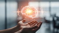 Human hands holding glowing brain with digital connections and light effects representing artificial intelligence, innovation and mental health concepts.