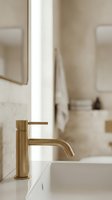 Modern brass faucet on white bathroom sink with neutral beige tile walls and mirrors, showcasing contemporary interior design and home decor styling.