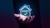Hands holding glowing neon house icon with 2027 year and checkmark symbol on dark blue background. Real estate, property investment, future home planning.