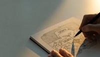 Person drawing intricate geometric patterns and mandala designs in sketchbook with pen, creative art process under warm lighting for relaxation and mindfulness.